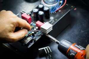 Hands repairing a computer